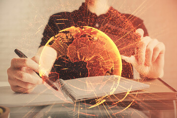 Double exposure of man hands holding a credit card and social network theme drawing. Digital finance and E-commerce concept.