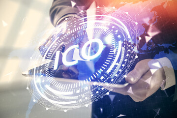 Double exposure of man's hands holding and using a phone and crypto currency blockchain theme...
