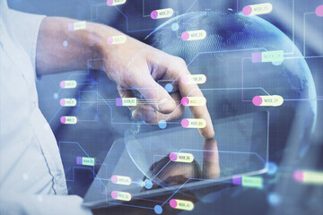 Double exposure of man's hand holding and using a digital device and data theme hologram drawing. Technology concept.