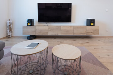 Cabinet and TV with speakers in living room of modern apartment