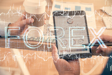 Double exposure of man's hands holding and using a phone and financial chart drawing. Market analysis concept.