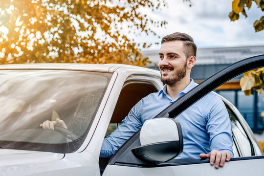 Good Looking Man About To Enter His Car On A Beautiful Autumn Day Outside