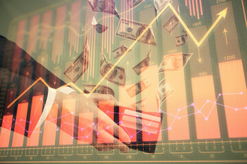 Multi exposure of financial graph drawing hologram and USA dollars bills and man hands. Analysis...