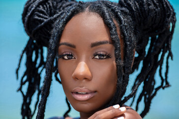 Headshot of a sensual looking attractive young black female with beautiful makeup & long dreadlocks...