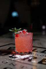 Making cocktails at home like an expert nightclub barman. Fresh and juicy colorful homemade cocktails garnished with berries, orange, cherry  on dark background.