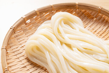 Japanese Ingredients.Cold udon noodles on a bamboo colander