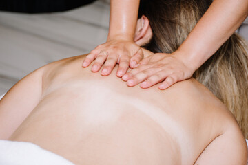 Fototapeta na wymiar woman getting an oil back massage while laying down