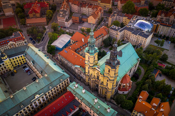 Aerial high angle view of the Parish of St. John the Baptist and old town buildings at sunset. Topdown view on dense old urban development in Legnica, Poland