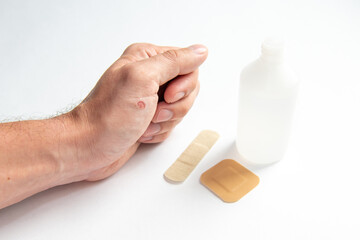 disinfecting the wound on the hand and applying a patch