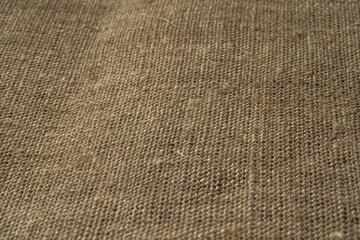 Fabric texture close up, rough brown canvas background, macro shot.