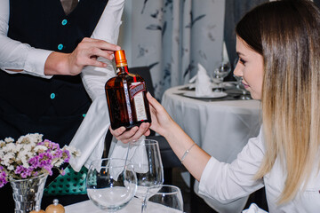 Woman picking what type of alcohol she wants to drink at a restaurant