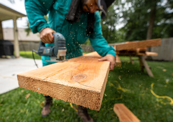 Carpenter sawing wood 