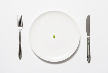 A single pea on a plate
