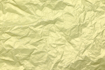 Golden crumpled paper background. Yellow crease paper texture. Copy space. Place for text