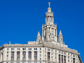 Fototapeta na wymiar tall white building with a bright blue sky behind