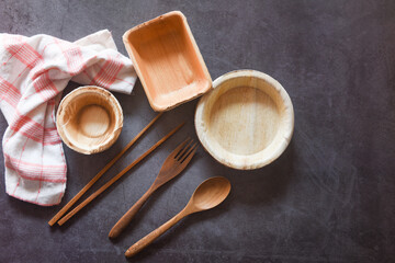 Eco friendly disposable tableware from palm leaf or betel nut , zero waste environment concept Natural eco-friendly food packaging disposable utensils with dish plate bowl cup and wooden fork spoon