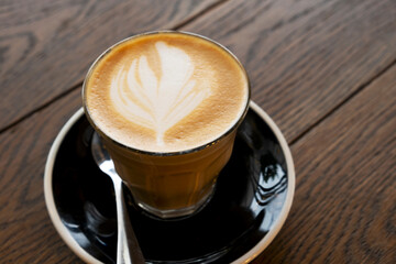 Hot latte on a wooden table