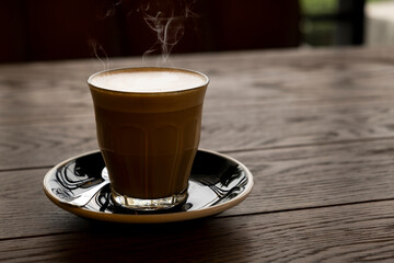 Hot latte on a wooden table