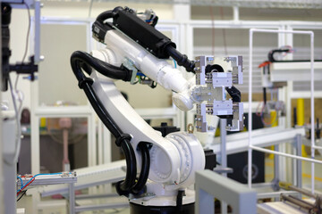 Factory 4.0 concept: View of gripper unit on handerling robot arm of automation machine.