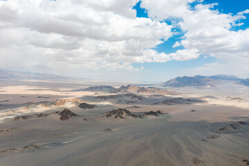aerial view of sand moutain in desert with blue sky