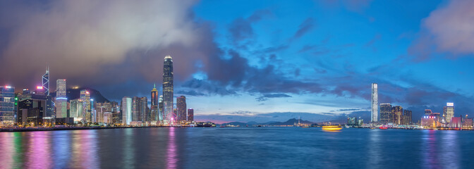 Fototapeta na wymiar Panorama of Skyline and harbor of Hong Kong city at dusk