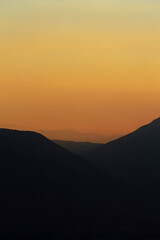 Mountains view, sunset at the top of a mountain after a trekking.