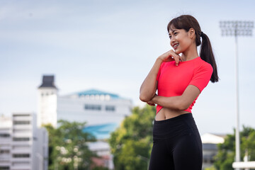 Portrait of a fit and frim young woman wears sport clothes ready to workout in the city stadium in the morning. Healthy and recreation stock photo.