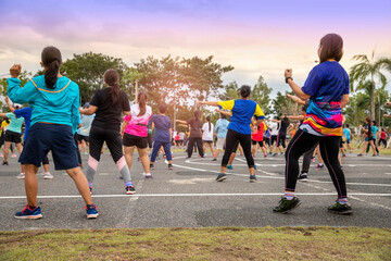 Fototapeta premium Chiang Mai, THAILAND - July 11: People doing aerobic dance after work for exercise at Royal Park on July 11, 2019 in Chiang Mai, Thailand.