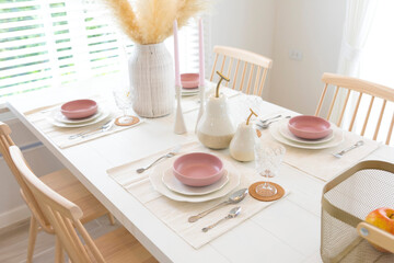 Fototapeta na wymiar Elegance purple dining set on wooden table with beautiful flower vase