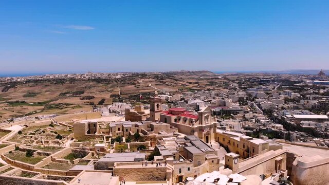Cittadella, fortress from medieval era drone aerial shot fly backward, Gozo island reveal, Malta