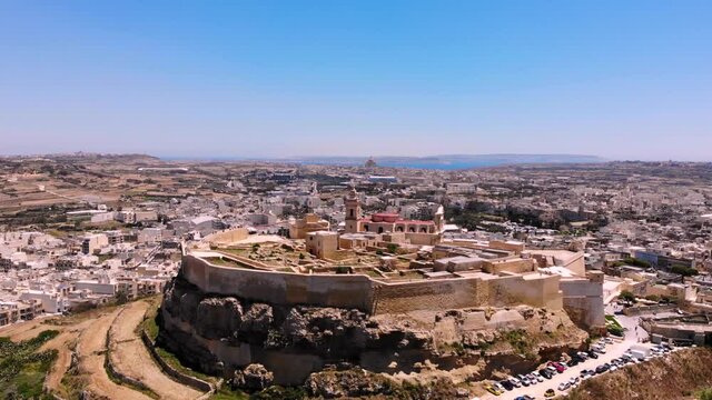 Cittadella aerial drone pan shot, fly forward to medieval fortress, Gozo, Malta.