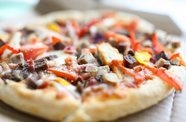 Cardboard box lies beautiful pizza with vegetables