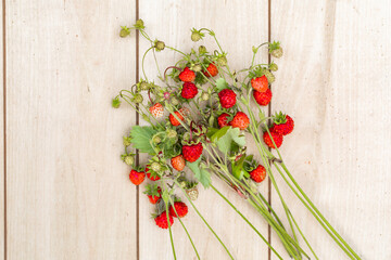 Red ripe juicy strawberries on a wooden background