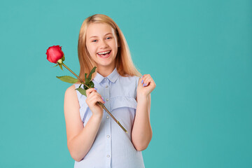 A happy girl is delighted with a gift-a red rose