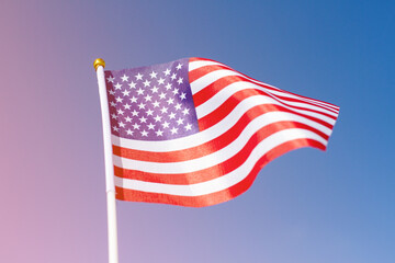 Fototapeta premium USA flag waving in blue sky. American flag mockup with the space for your content. Design