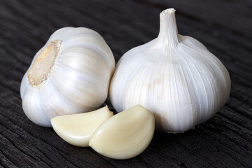 Fresh garlic on dark wooden background.