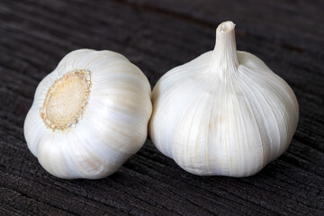 Fresh garlics on dark wooden background.