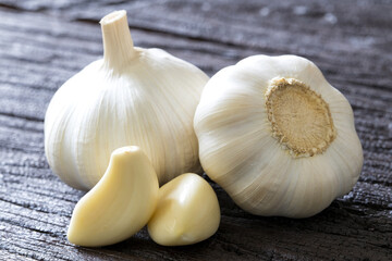 Fresh Garlic Bulb and Cloves on dark wooden background