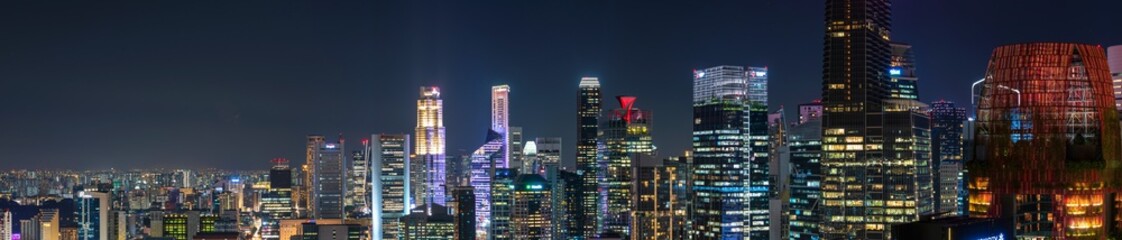 Wide panorama image of Singapore skyscrapers at night