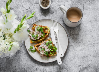 Delicious healthy breakfast, brunch, snack - zucchini waffles with tuna, cream cheese pate and coffee on a gray background, top view