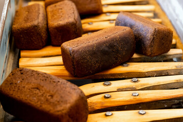 Automatic production line baked black brown breads from hot oven