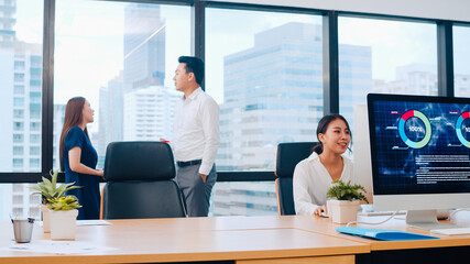 Collaborative process group of multicultural business people in smart casual wear communicating and using technology while working together in creative office. Asia team of young professionals work.