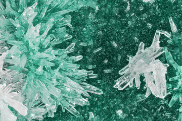 cyan and white crystals on dark crystalline background