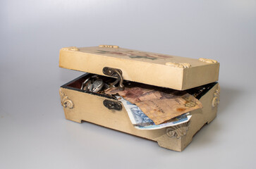 small carved box with old coins