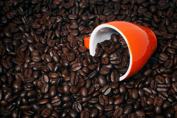 coffee cup laying on coffee beans mockup