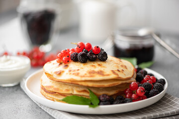 homemade pancakes with fresh berries and jam