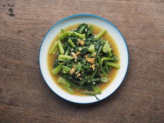 Top view stir-fried spinach and bok choy with soy sauce and garlic.
