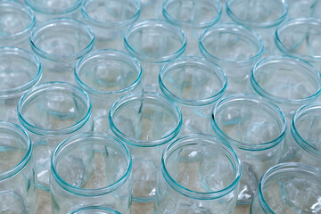 transparent empty glass bottles in a bottling plant, on a production line in a factory or for sale in a store