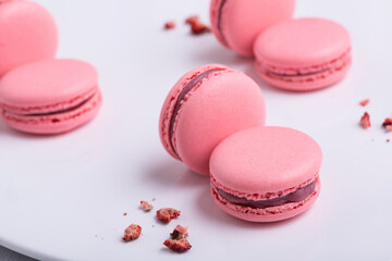 pink Macaroni cookie French on white plate. Studio photo