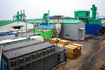 Fototapeta na wymiar The Environment of machine and storage building around Wood Pellet factory in Asia.